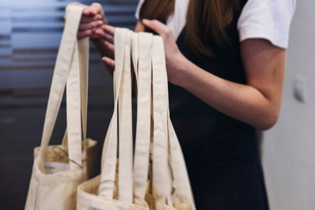 White beige cotton shopper bag with corporate gifts and souvenirs for company employees, gift...