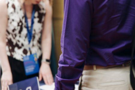 Process of checking in on conference congress forum event, registration desk table, visitors and...