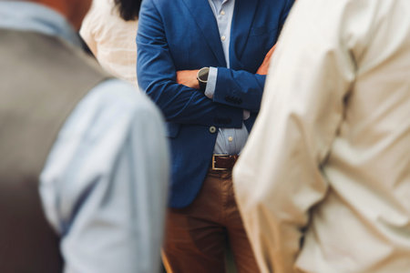 Group of men in business suits talking and discussing during coffee break at conference, politicians...