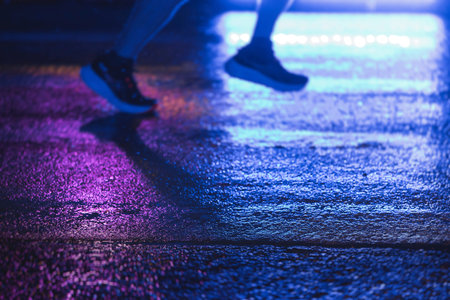 Night marathon runners crowd in the rain, sportsmen participants start running the half-marathon in...