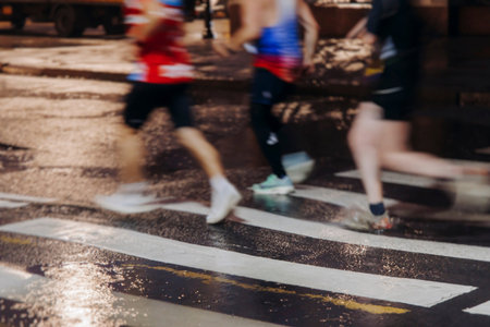 Night marathon runners crowd in the rain, sportsmen participants start running the half-marathon in...