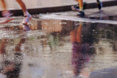Night marathon runners crowd in the rain, sportsmen participants start running the half-marathon in...