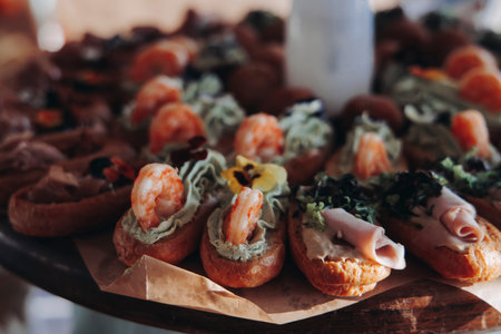 Beautifully decorated banquet catering table, with variety of with different food snacks appetizers...