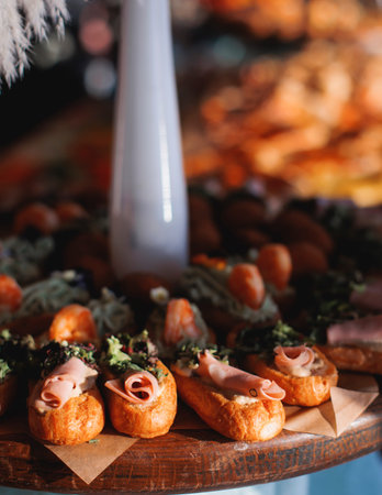Beautifully decorated banquet catering table, with variety of with different food snacks appetizers...