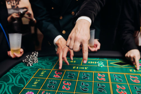 Casino table with roulette wheel in motion, with casino chips, tokens, the hand of croupier, dollar...