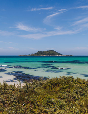 Jeju Island, white sand beach and sea, landscape view in a sunny day, and Biyangdo island