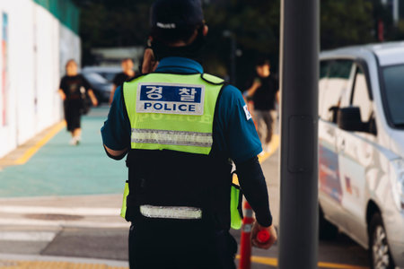 Korean Police squad formation in protective uniform, policemen officer patrol maintain public during...