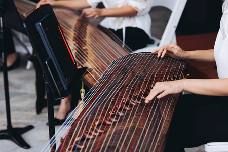 Traditional Korean folk musical instrument Gayageum, female orchestra band performing concert on...