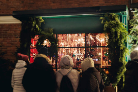 Christmas market with illuminated food stalls, gift shops and kiosks, New Year outdoor fair...