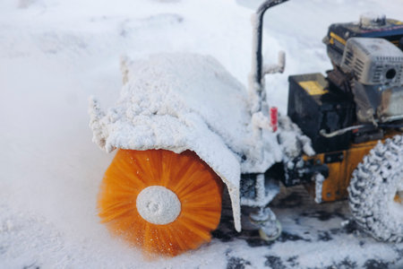 Removing snow with portable blower machine during winter, worker with gas snow blower removal in the...
