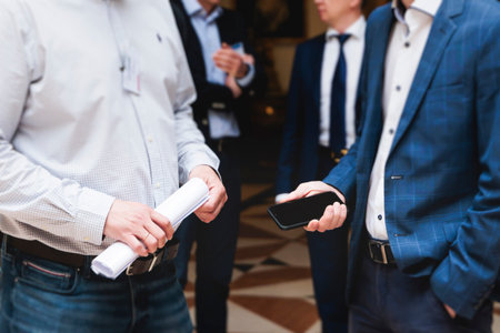 Group of men in business suits talking and discussing during coffee break at conference, politicians...