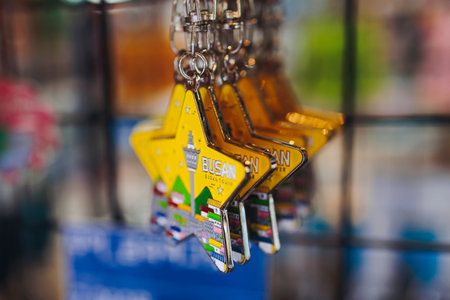 Tourist gifts and Korean souvenirs from Busan, South Korea,  toys and figurines, fridge magnets and key ring keychain, key fobs and postcards with symbols of Busan in a local gift vendor shop market