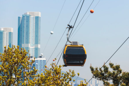 Busan Air Cruise, Busan cable car, ride on multicoloured sky capsule gondola route, with Songdo beach and Skywalk and Busan Bay panorama, South Korea, Songdo Station in a spring sunny day