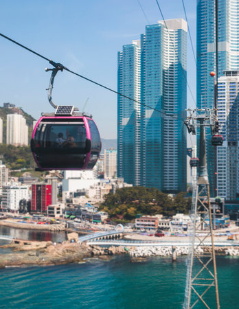 Busan Air Cruise, Busan cable car, ride on multicoloured sky capsule gondola route, with Songdo beach and Skywalk and Busan Bay panorama, South Korea, Songdo Station in a spring sunny day