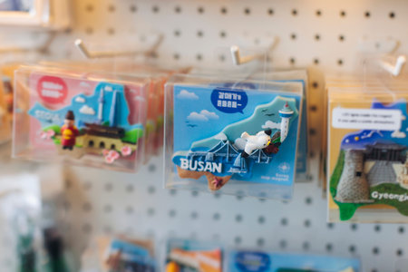 Tourist gifts and Korean souvenirs from Busan, South Korea,  toys and figurines, fridge magnets and key ring keychain, key fobs and postcards with symbols of Busan in a local gift vendor shop market