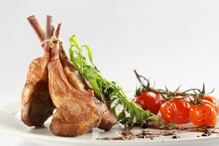 Rack of lamb with roasted cherry tomatoesの写真素材