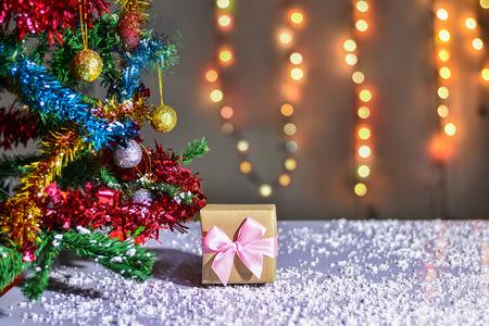 Gift Box in christmas day with christmas tree and Blur light Background.の写真素材