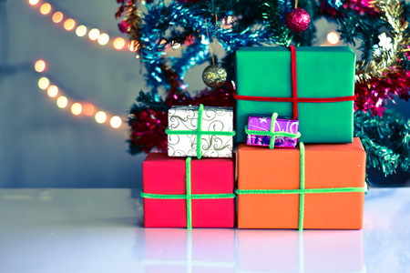 Gift Box in christmas day with christmas tree and Blur light Background.の写真素材