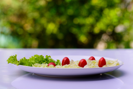Salad on white table with a background blur bokeh.の写真素材