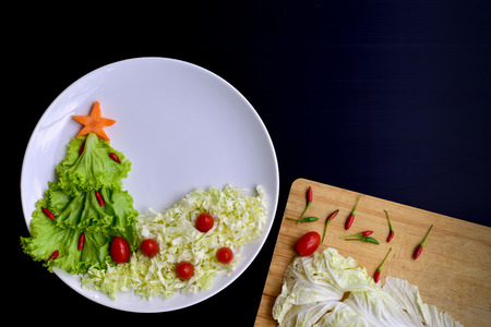 Christmas tree made of lettuce on a white dish Isolated.の写真素材