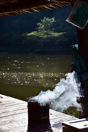 Charcoal grills smoke along the River Kwai.の写真素材