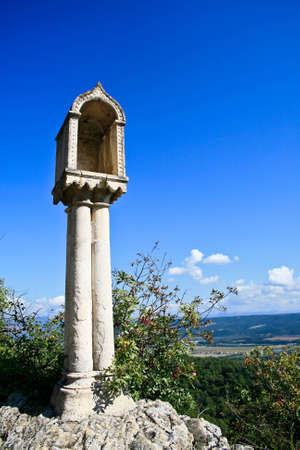 Vacant shrine perches on a rock overlooking the Luberon valley against a blue sky in Lurs, Provence.  (Shot with polariser)の写真素材