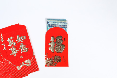 Chinese New Year decoration of ang pow with Chinese Caligraphy of the words "Fook" and "Wanshiruyi" meaning Wealth,fortune, dreams come true and luckyの写真素材