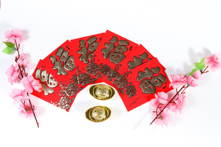Chinese New Year decoration with cherry blossom, yuan bao and Chinese Caligraphy words of 'Fook" meaning prosperity, wealth, lucky, on red ang powの写真素材
