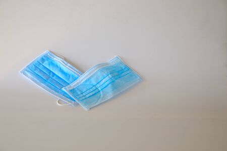 Two disposable surgical masks isolated on white blackground