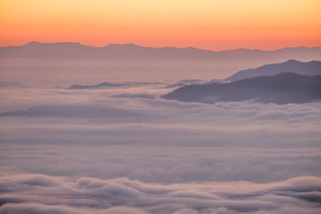 sunrise and the mist on top of the mountainの写真素材