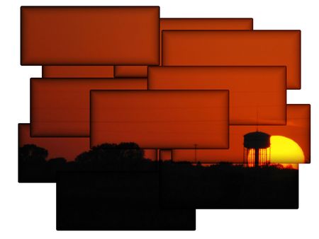A beautiful sun setting behind a water tower in a unique framingの写真素材