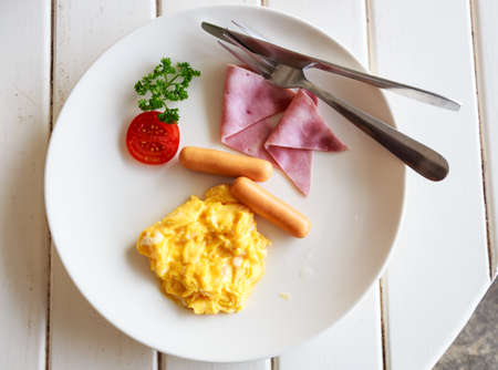 breakfast with white plate egg and sausage