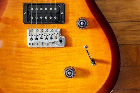 electric guitar cutwat sunburst colour on wooden floorの写真素材