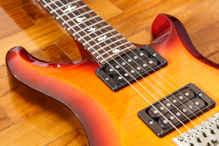 electric guitar cutwat sunburst colour on wooden floorの写真素材