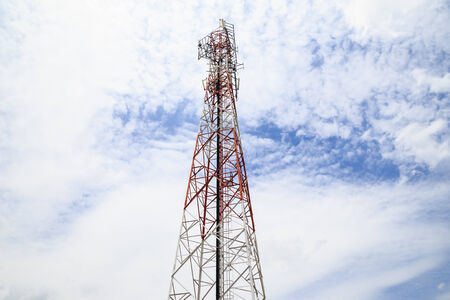 Telecommunication broadcasting tower with cloudy skyの写真素材