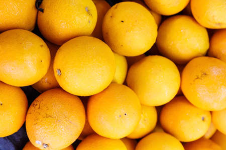 pile of fresh orange fruit in the fruit marketの写真素材