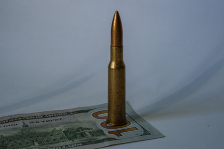rifle cartridge 7.62 54 R still life on a background of a hundred dollar bill