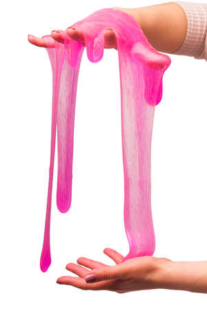 a toy for children mucus and liquid flowing on hand on a white background