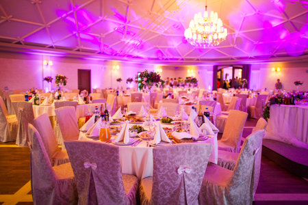beautiful interior of a large festive hall and decorated tables with foodのeditorial素材