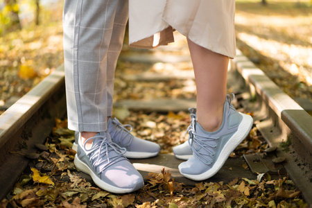 stylish modern couple in love in identical shoes sneakersの写真素材
