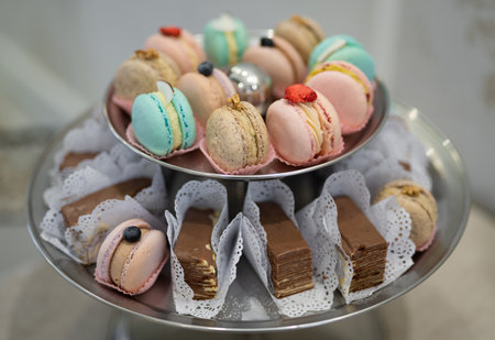 various delicious macaron cookies on a round stand tray