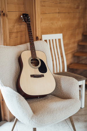 full size classical acoustic guitar on chair in interior