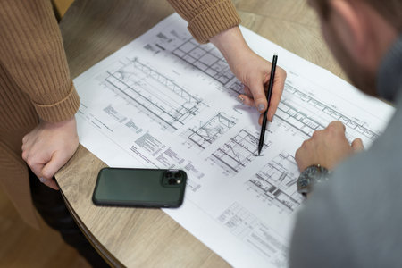 construction project drawings are discussed by construction company employees