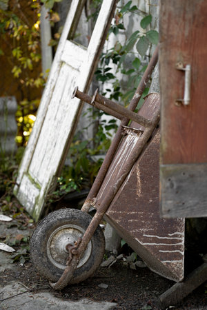 A metal wheelbarrow with one wheel used by workers in construction or gardening