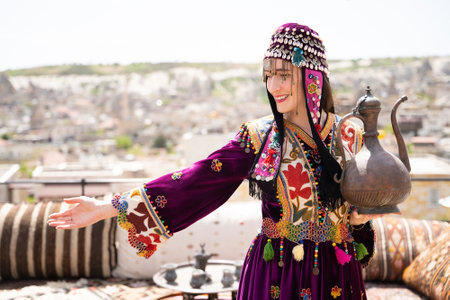 beautiful girl in Turkish national clothes with a teapot in her handsの写真素材