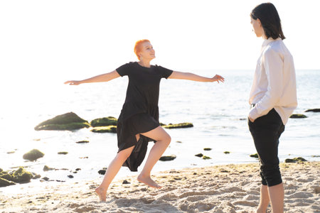two lovers boy and girl are happy walking and hugging on the sandy beach near the seaの写真素材