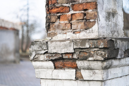 texture of old cracked and destroyed red brick wallの写真素材