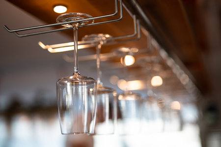 empty clean glass glasses for alcoholic drinks in a restaurant on a bar counterの写真素材