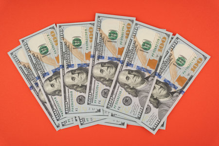 100 dollar bills on a red backgroundの写真素材