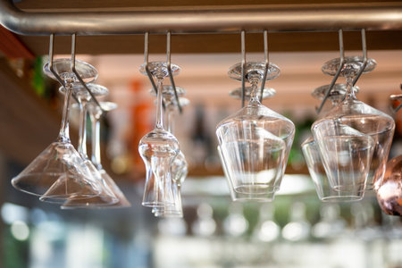 empty clean glass glasses for alcoholic drinks in a restaurant on a bar counterの写真素材